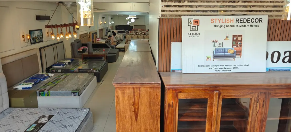 Inside the showroom, with the Stylish Redecor board and wooden dining furniture