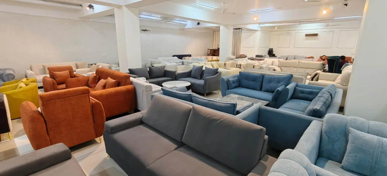 The showroom floor with dozens of sofa sets in grey, blue, orange and cream