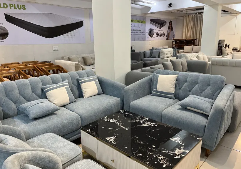 Blue-grey fabric sofa sets around a black marble centre table